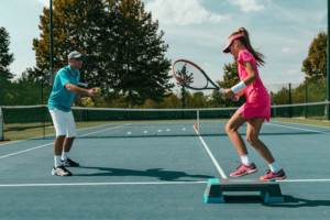 102156489 - tennis instructor with young girl on tennis training